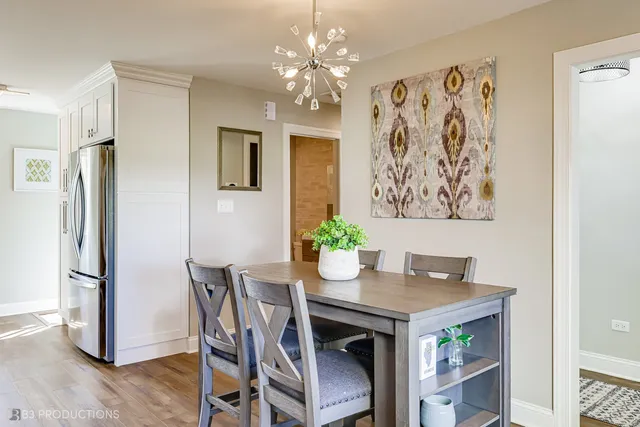a view of a dining room with furniture wooden floor and a chandelier