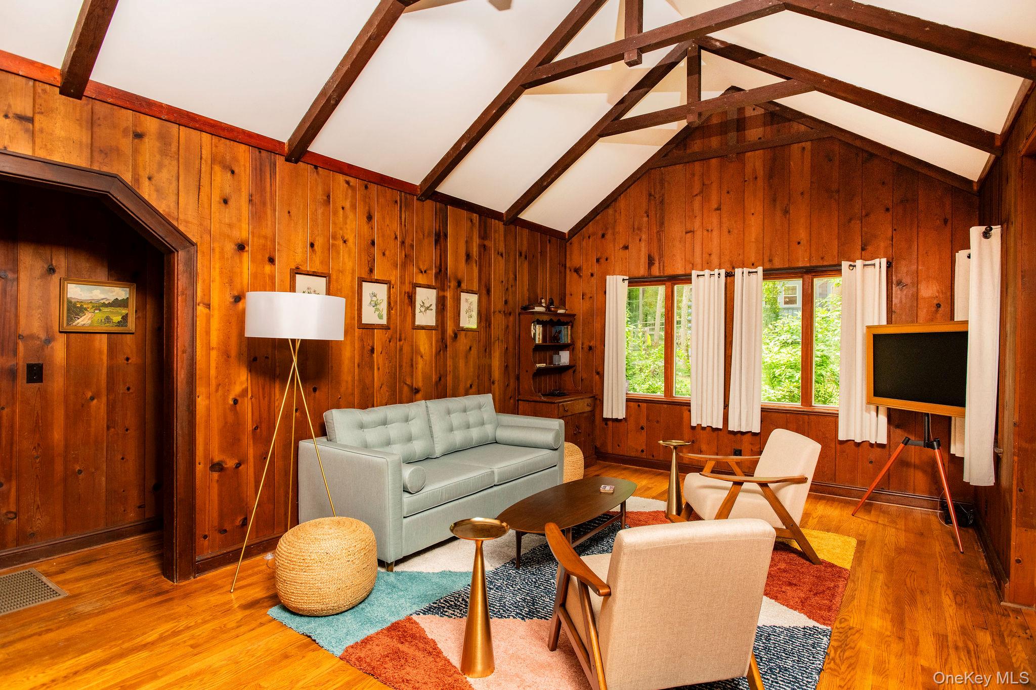 11 Locust Drive Cold Spring, NY 10516 - Photo 3 of 23 Spacious living room with working fireplace, pull out queen sofa bed, smart TV, and cozy modern furnishings.