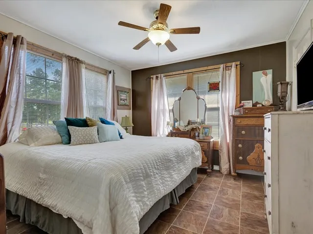 a bedroom with a bed and glass walk in closet
