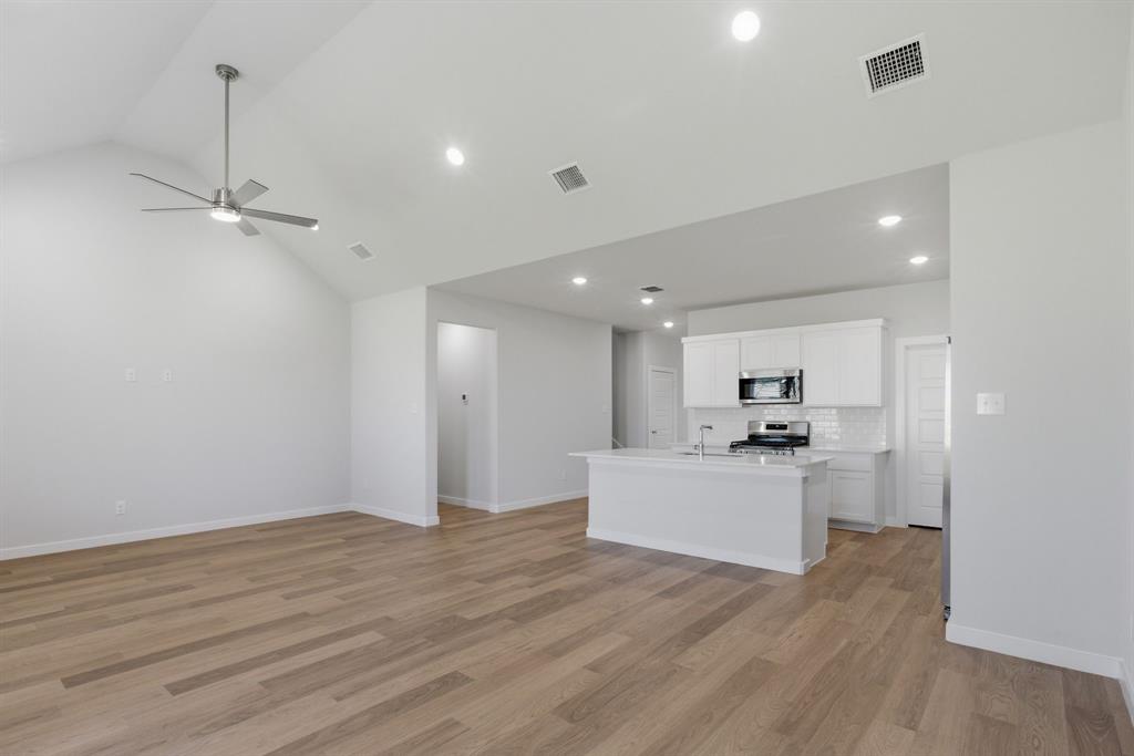 637 Sierra Ridge Lavon, TX 75166 - Photo 6 of 26 a view of a kitchen with a sink stainless steel appliances and wooden floor