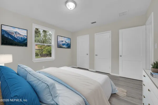 a bedroom with a bed and a window