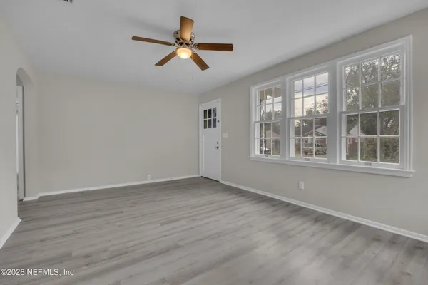a view of a livingroom with a ceiling fan and window