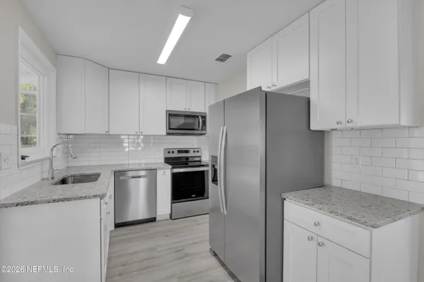 a kitchen with a sink stove and refrigerator