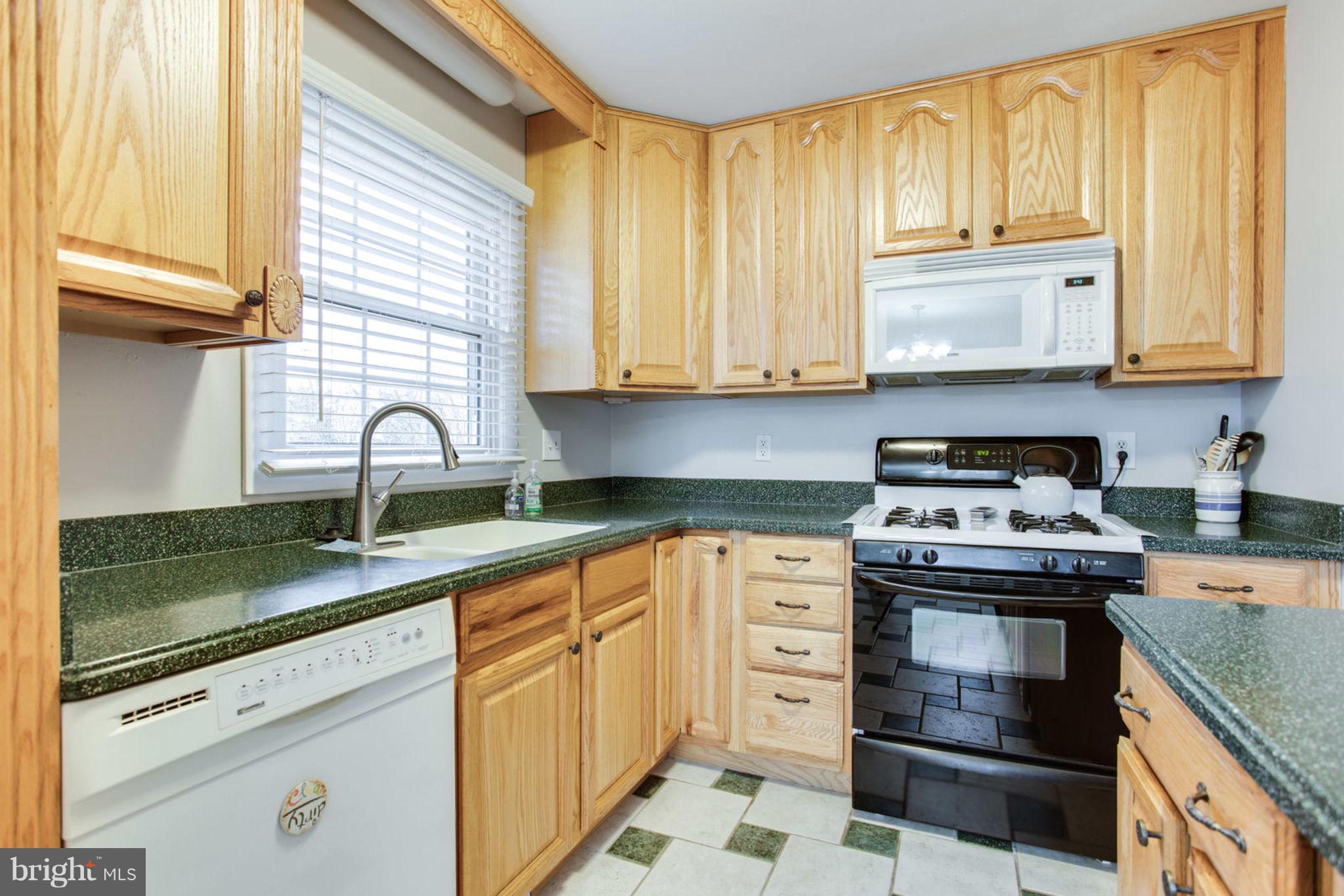 1625 Thomas Drive Point of Rocks, MD 21777 - Photo 18 of 47 a kitchen with granite countertop a sink a stove and cabinets