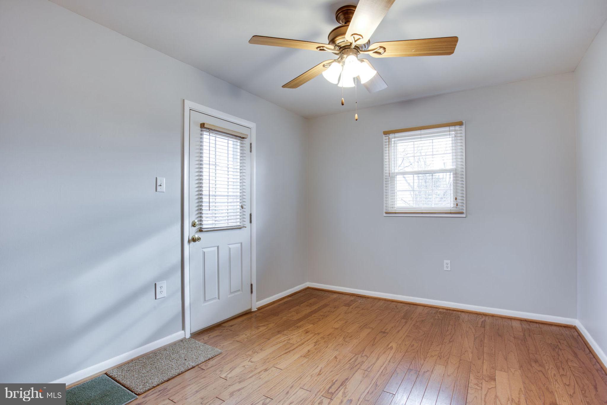 1625 Thomas Drive Point of Rocks, MD 21777 - Photo 26 of 47 an empty room with wooden floor fan and windows