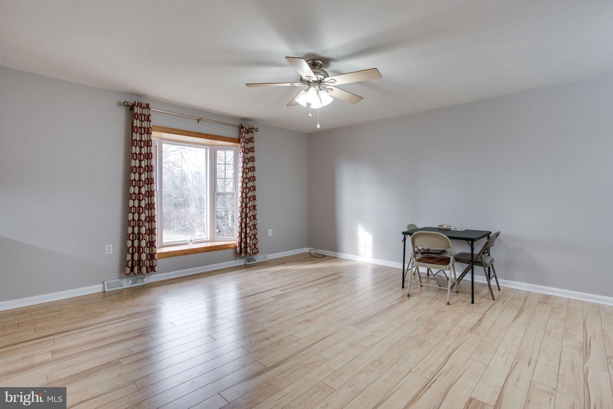 1625 Thomas Drive Point of Rocks, MD 21777 - Photo 6 of 47 a view of a livingroom with wooden floor and a ceiling fan