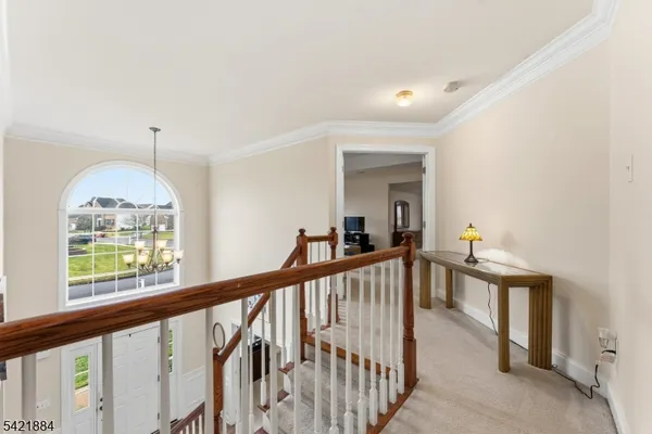 a view of a hallway view with wooden floor and staircase