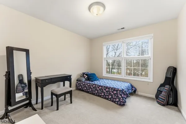 a bedroom with bed and a window