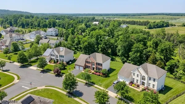 an aerial view of a house with garden space and street view