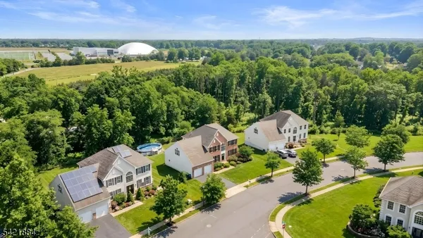 an aerial view of a house with garden space and street view