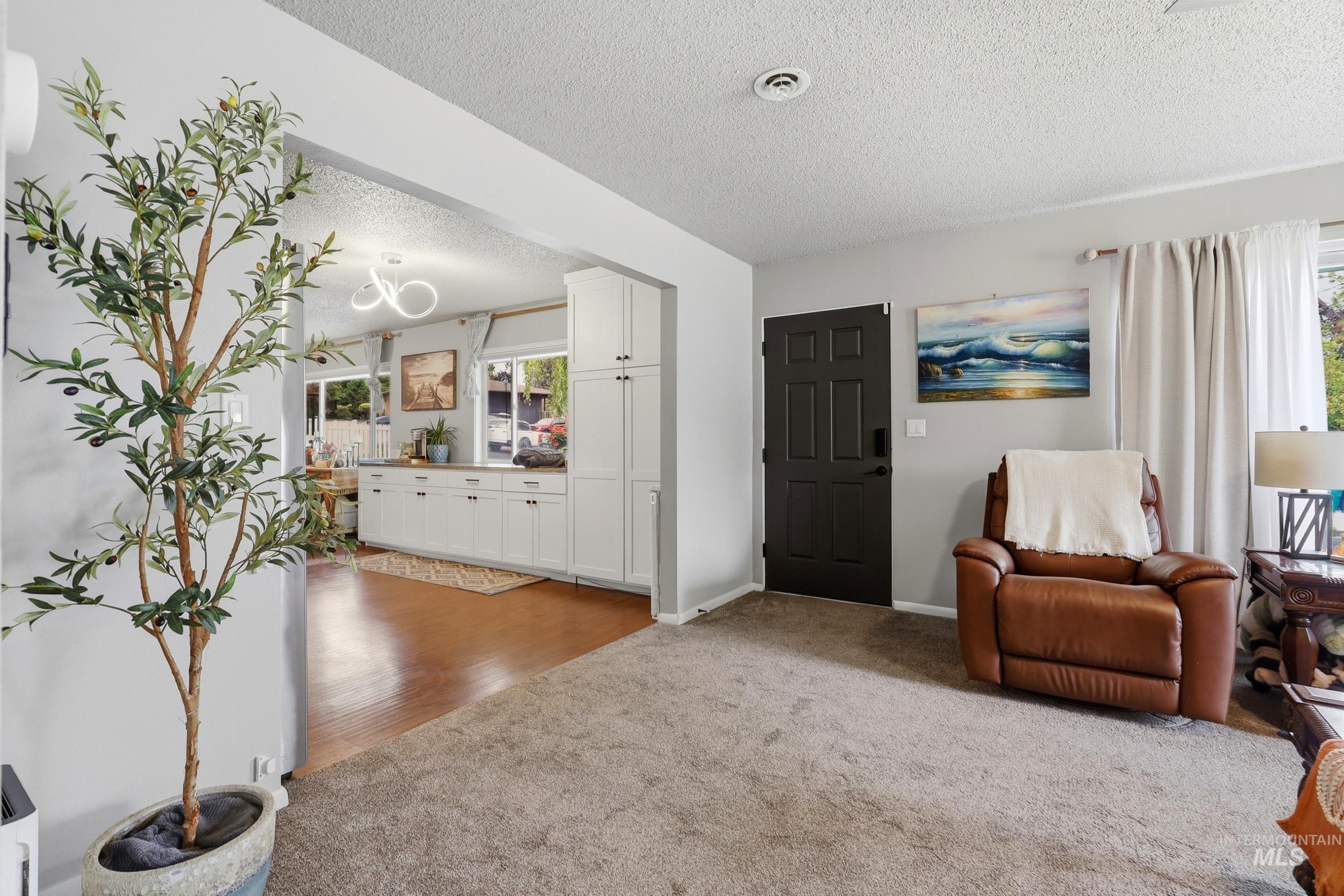 1803 14th Street Lewiston, ID 83501 - Photo 20 of 27 Recessed lighting, wood-finish flooring, white cabinetry, dark paneled door, and neutral wall tones