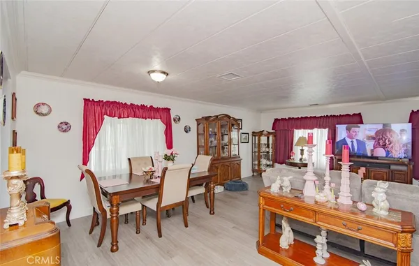 a dining room with furniture and wooden floor