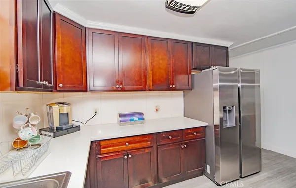 a kitchen with stainless steel appliances granite countertop a refrigerator and a sink