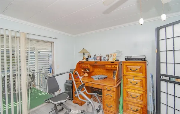 a view of a dining room with furniture and a chandelier fan