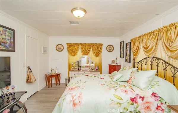 a bedroom that has a bed and a flat screen tv