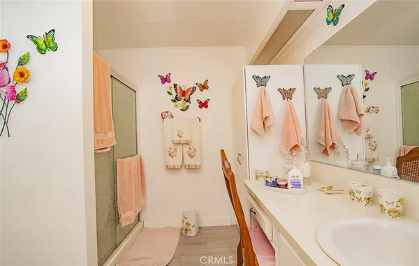 a bathroom with a sink a toilet and shower curtain