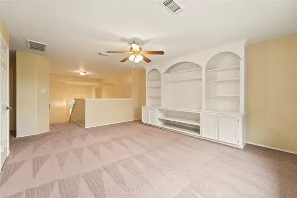 a view of a livingroom with a chandelier fan