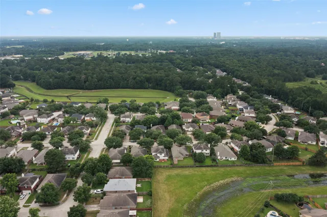an aerial view of a house with a yard