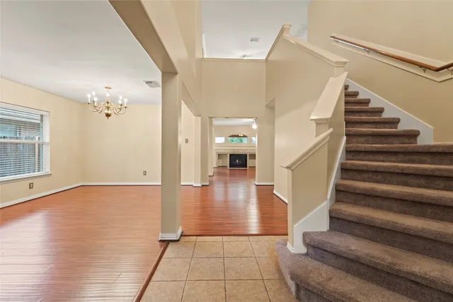 a view of an entryway with wooden floor and a chandelier