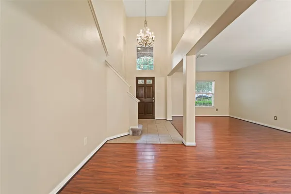 a view of livingroom with hardwood floor and kitchen space