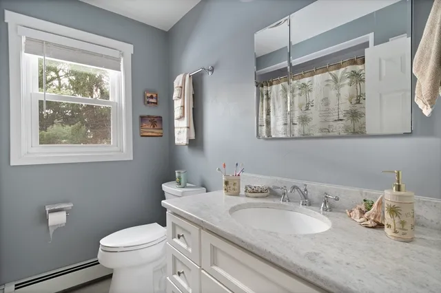 a utility room with dryer washer and a view of living room