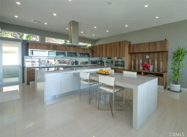 a kitchen with a sink and chairs