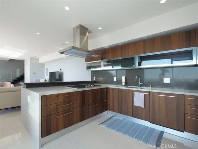 a kitchen with stainless steel appliances granite countertop a sink counter space and wooden floors