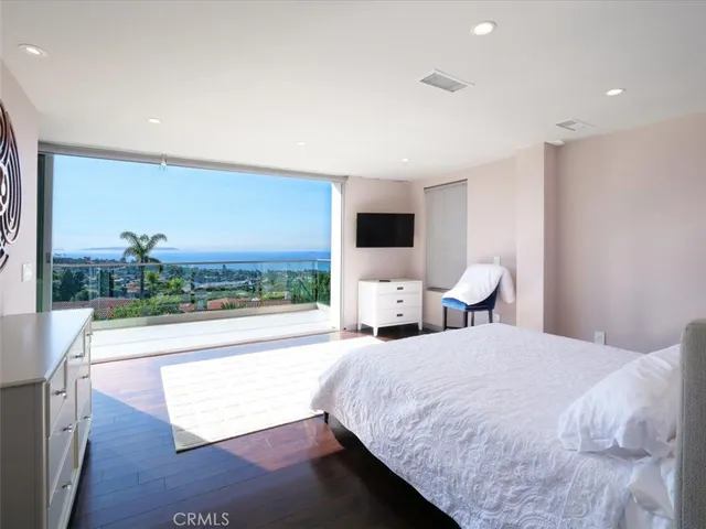 a spacious bedroom with a bed and a view of balcony