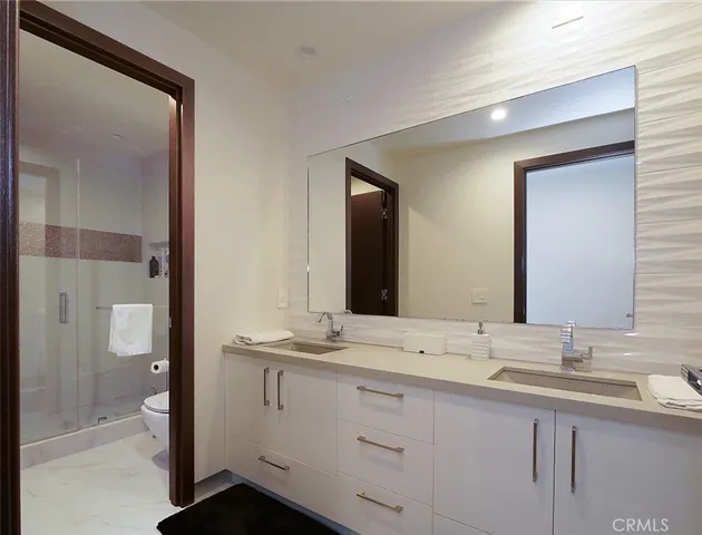 a bathroom with a double vanity sink and mirror