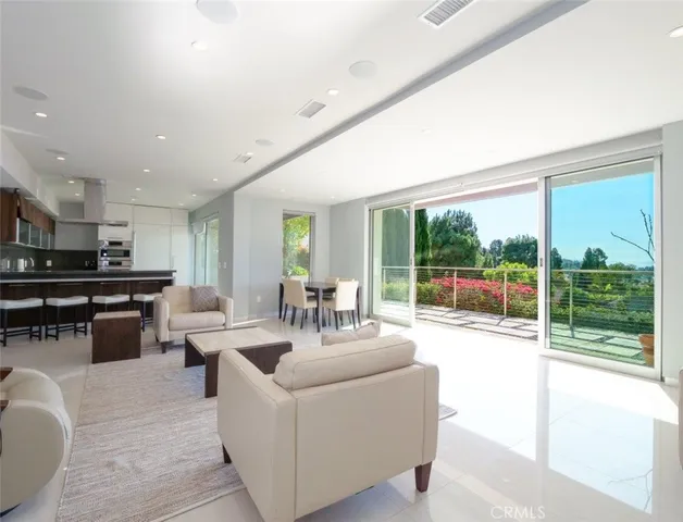 a living room with furniture and a floor to ceiling window