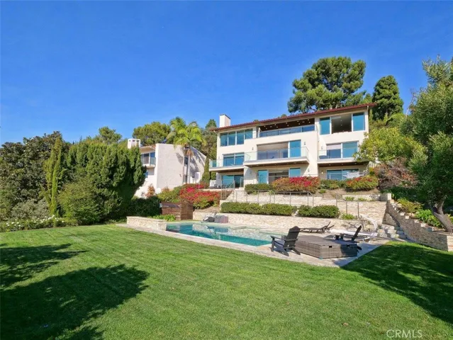 a house view with a sitting space and garden