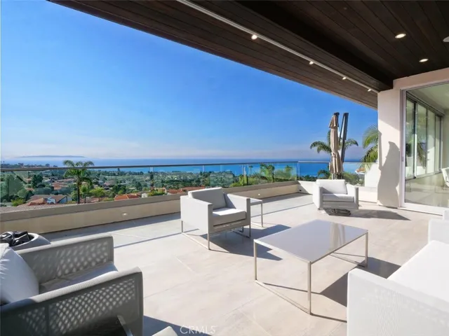 a view of balcony with couch and chairs