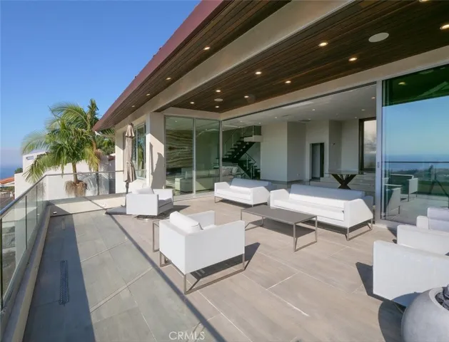 a building outdoor space with patio furniture and potted plants