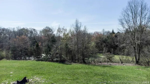 a view of a big room with windows and chandelier