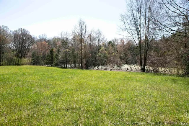 a view of empty room with a fireplace and windows