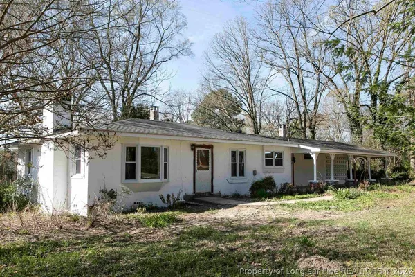 a front view of a house with a garden and porch