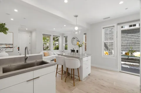 a kitchen with center island table and chairs in it