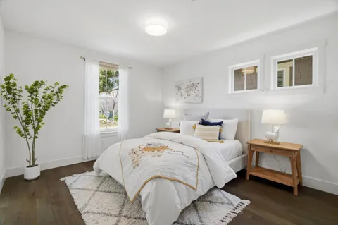 a bedroom with a large bed and a potted plant
