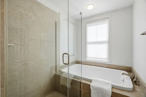 a bathroom with a tub and a window
