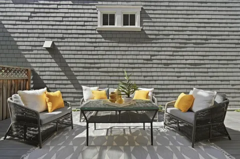 a backyard of a house with outdoor seating