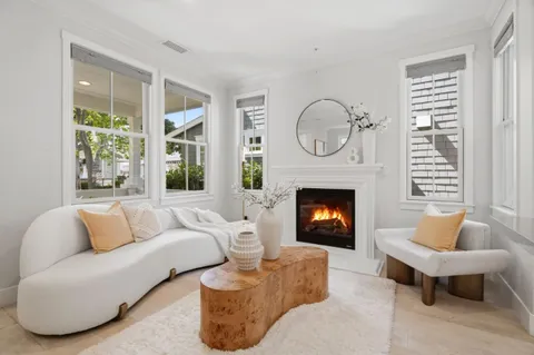 a living room with furniture a fireplace and window
