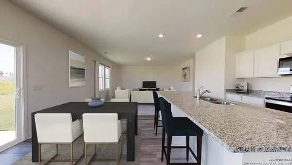 a large kitchen with a table and chairs in it