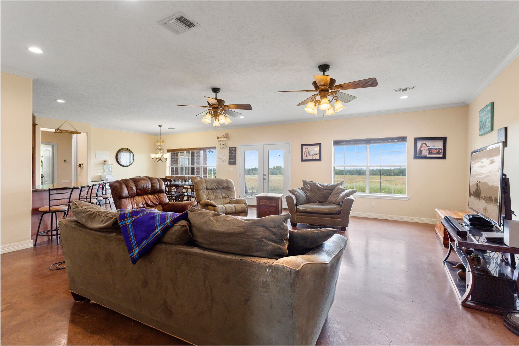 5750 Cedar Hill Road Brenham, TX 77833 - Photo 15 of 46 Imagine a life filled with connection in this vast open-plan living space, where the large dining area merges seamlessly with the kitchen – the heart of any home, designed for constant conversation and family togetherness.