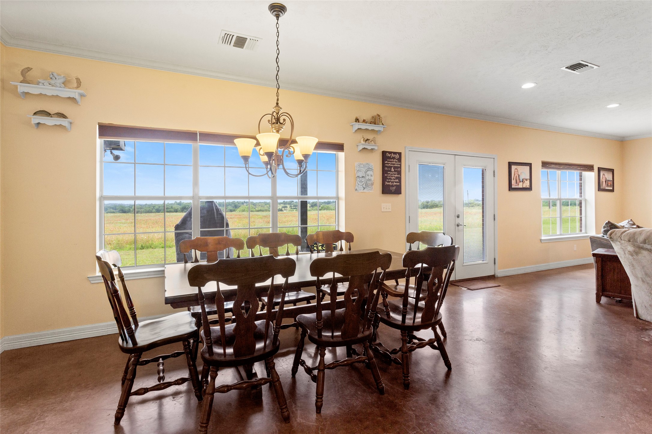 5750 Cedar Hill Road Brenham, TX 77833 - Photo 17 of 46 Envision festive Christmas celebrations in this dining area, where wonderful views of the lush greenery and expansive acreage provide a beautiful backdrop.