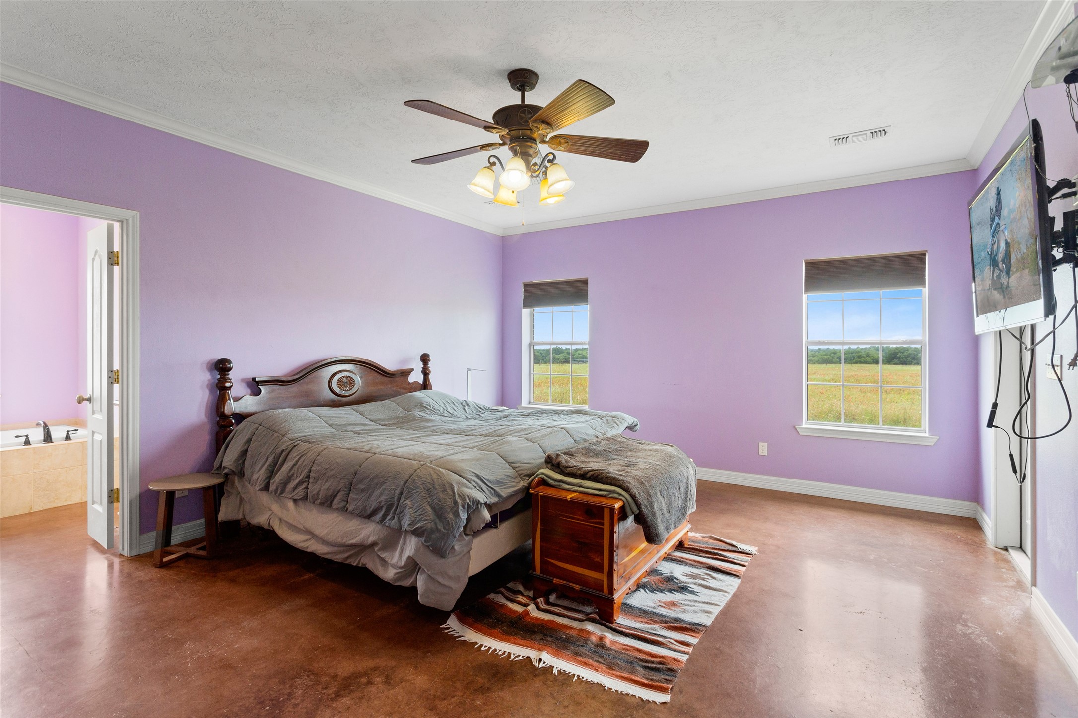 5750 Cedar Hill Road Brenham, TX 77833 - Photo 23 of 46 For your comfort and enjoyment, the massive main bedroom boasts a well-appointed en-suite and the practicality of his-and-hers closets.