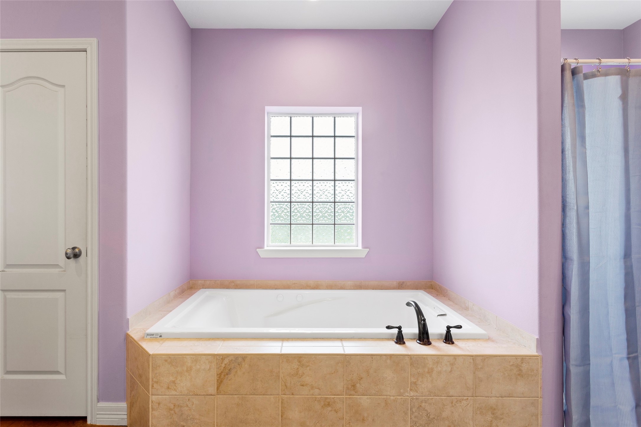 5750 Cedar Hill Road Brenham, TX 77833 - Photo 26 of 46 Indulge in the spacious en-suite bathroom, featuring a luxurious jetted tub and a separate, refreshing shower.
