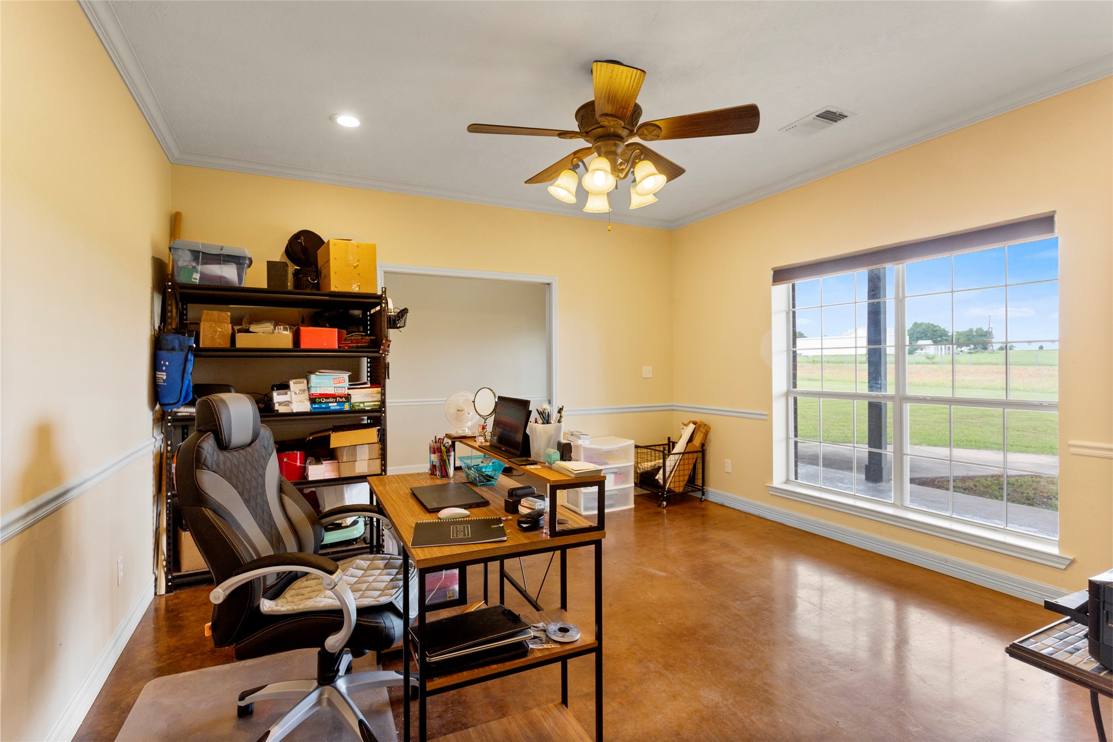 5750 Cedar Hill Road Brenham, TX 77833 - Photo 31 of 46 Another look at the generous flex room, where large windows seamlessly connect the interior with the property's picturesque natural surroundings.