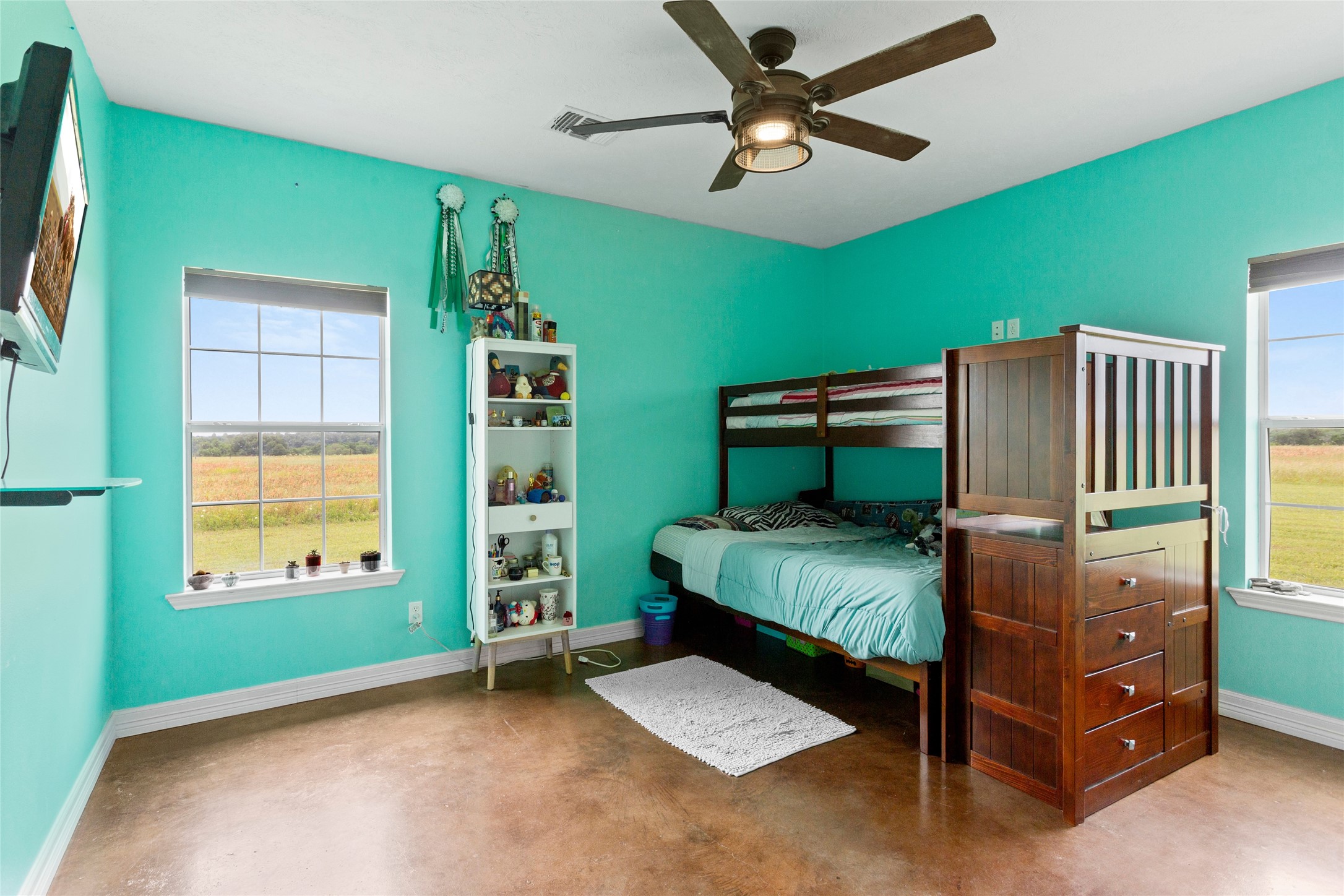 5750 Cedar Hill Road Brenham, TX 77833 - Photo 34 of 46 Natural light fills this generous second bedroom, thanks to windows overlooking the breathtaking surroundings.
