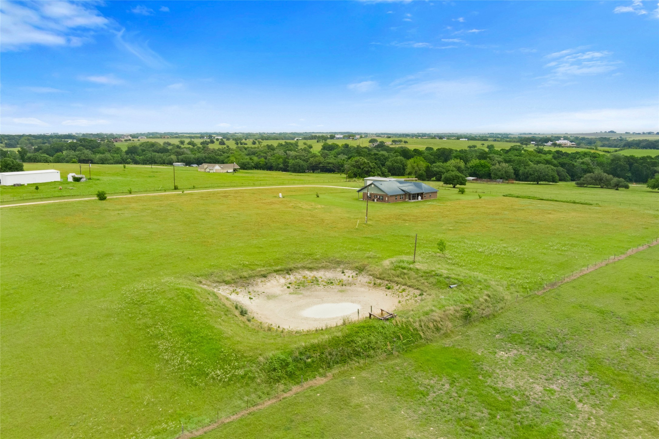 5750 Cedar Hill Road Brenham, TX 77833 - Photo 8 of 46 The pond's location and surrounding space present an excellent opportunity for future development, such as a deck or platform, to maximize enjoyment of the water feature and the views. The presence of electricity near the pond would further enhance this potential.