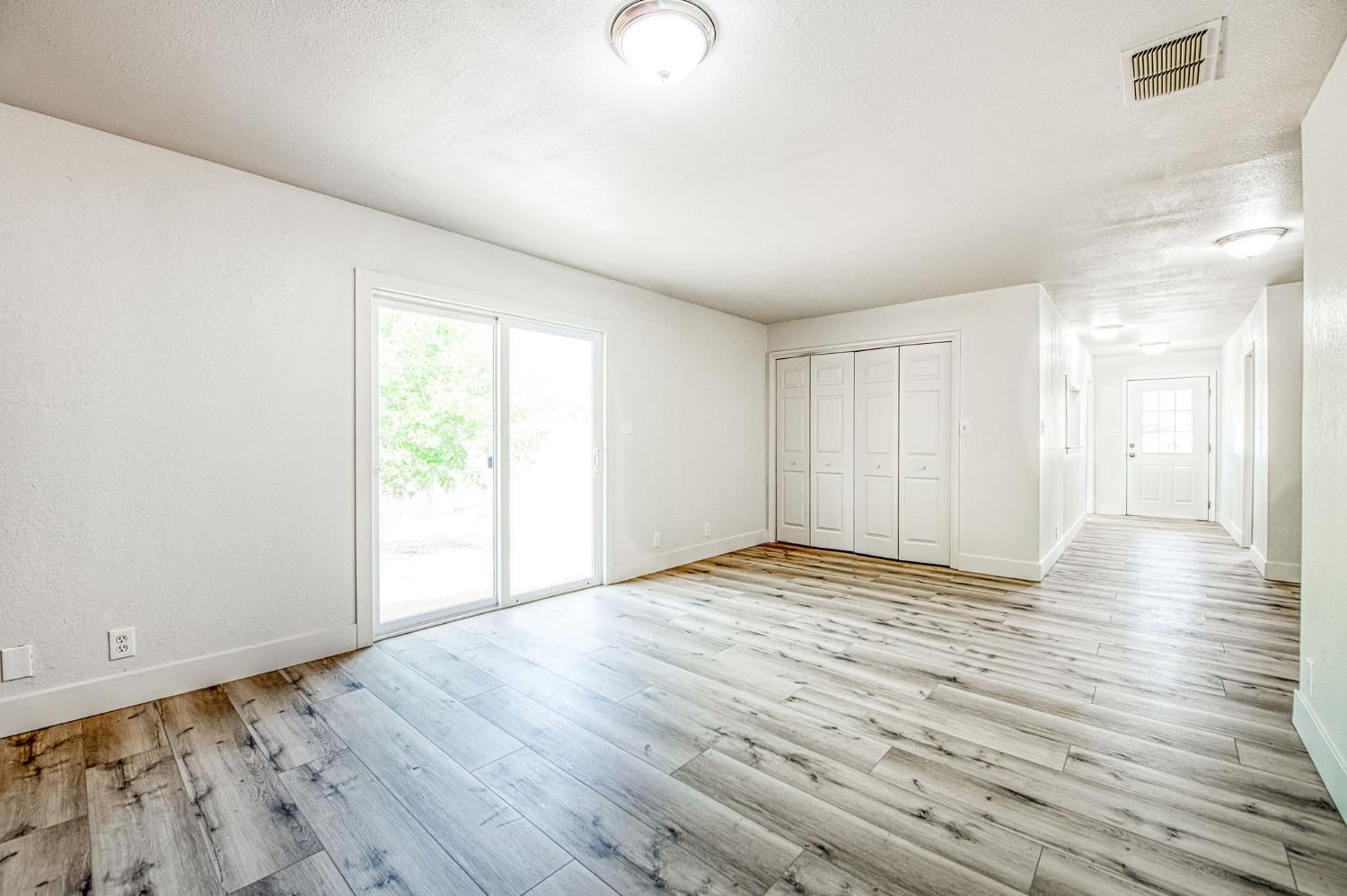 29531 Morgan Canyon Road Prather, CA 93651 - Photo 13 of 42 a view of an empty room with wooden floor and a window